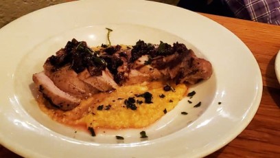 Pork Loin with smoked cheddar grits, pear chutney, and sage