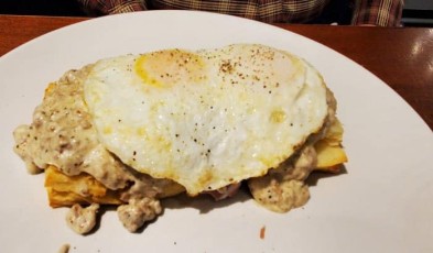 Southern Benny: Open-Faced Buttermilk Biscuit topped with shaved country ham, 2 over easy eggs, and sausage gravy