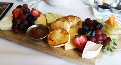 Chef's daily selection of artisanal cheeses, house pickles, red grapes, seasonal berries, apple, grilled bread, and local apple butter