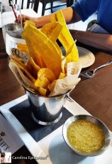 Mariquitas - the Cuban name for green plantain chips sliced lengthwise, served with Mojo, a traditional citrus sauce