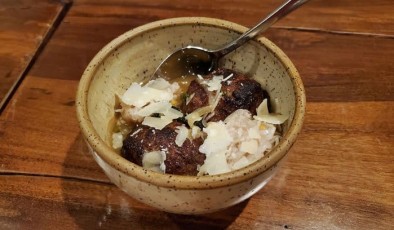 Tsukune (meat balls) made with maple tare , egg yolk,  scallion, and togarashi