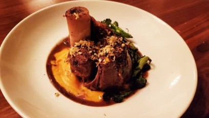 Venison Shank served with sweet potato puree and grilled broccoli, finished in its own braising au jus and topped with lemon rosemary garlic gremolata.