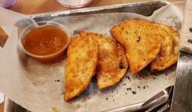 Duck Wontons: Crispy fried wontons stuffed with duck bacon, sweet corn, and cream cheese served with apricot jezebel jam.