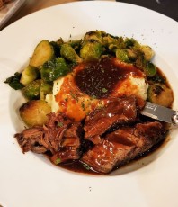 Homestyle Pot Roast: low & slow red wine- garlic seared angus beef check roast, butter & cream mashed potatoes, sauteed brussel sprouts, and malbec demi glace gravy.
