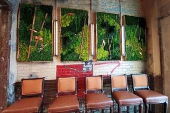 "Living Wall" panels with tobacco field stakes from a local farm.